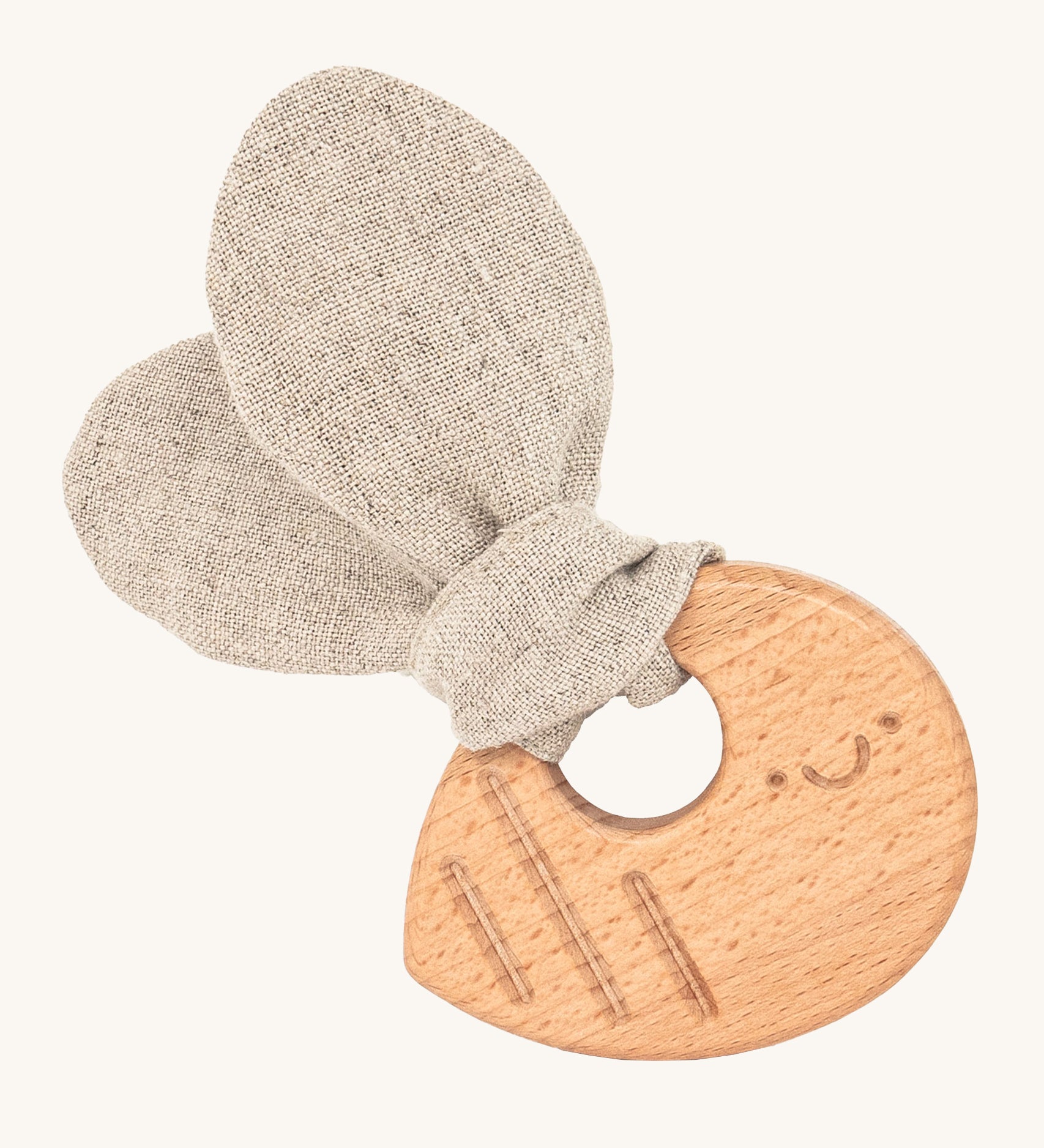 The Hempions Bee Baby Teether is an adorable baby teething toy made from natural hemp textile and solid wood, in the shape of a bee. The image shows the wooden textured bee teething ring with a light grey/beige hemp bee wing shaped fabric attached to it, on a cream background