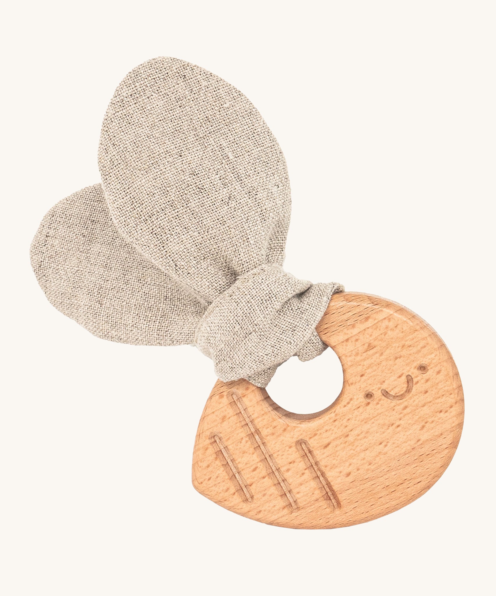 The Hempions Bee Baby Teether is an adorable baby teething toy made from natural hemp textile and solid wood, in the shape of a bee. The image shows the wooden textured bee teething ring with a light grey/beige hemp bee wing shaped fabric attached to it, on a cream background