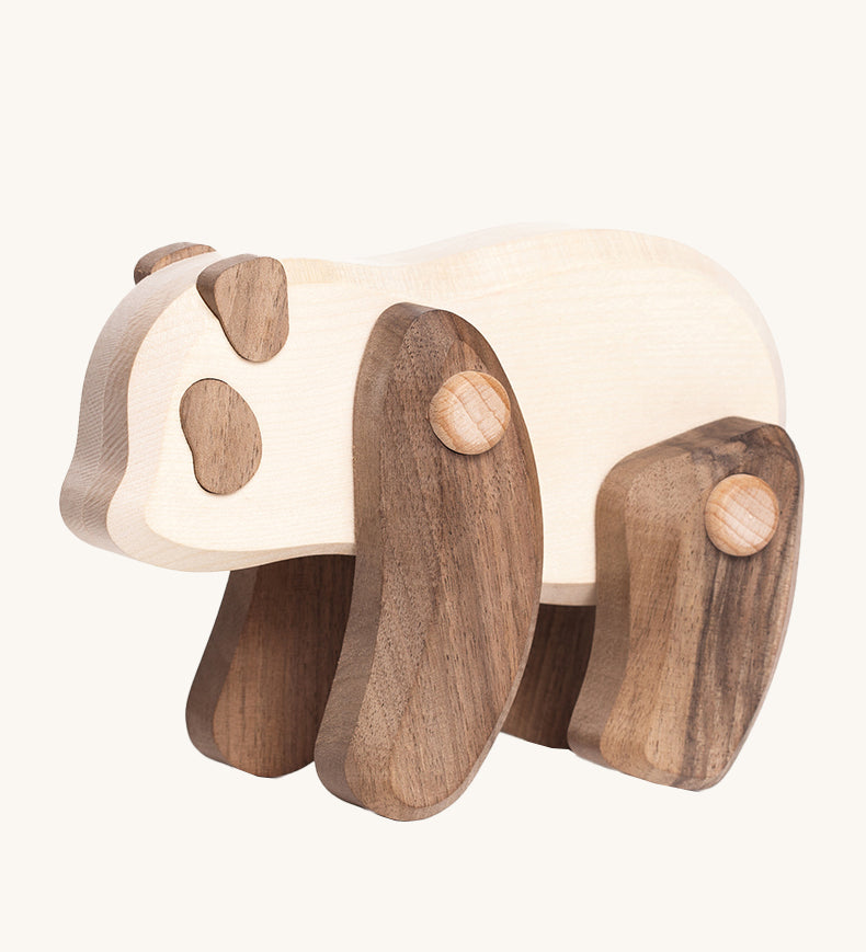 Tobe Wooden Panda baby toy, is beautifully crated in two tone wood, with a white body, dark brown arms and legs, dark brown ears and eye patches. This wonderful wooden toy has movable arms and legs, and is on a cream background