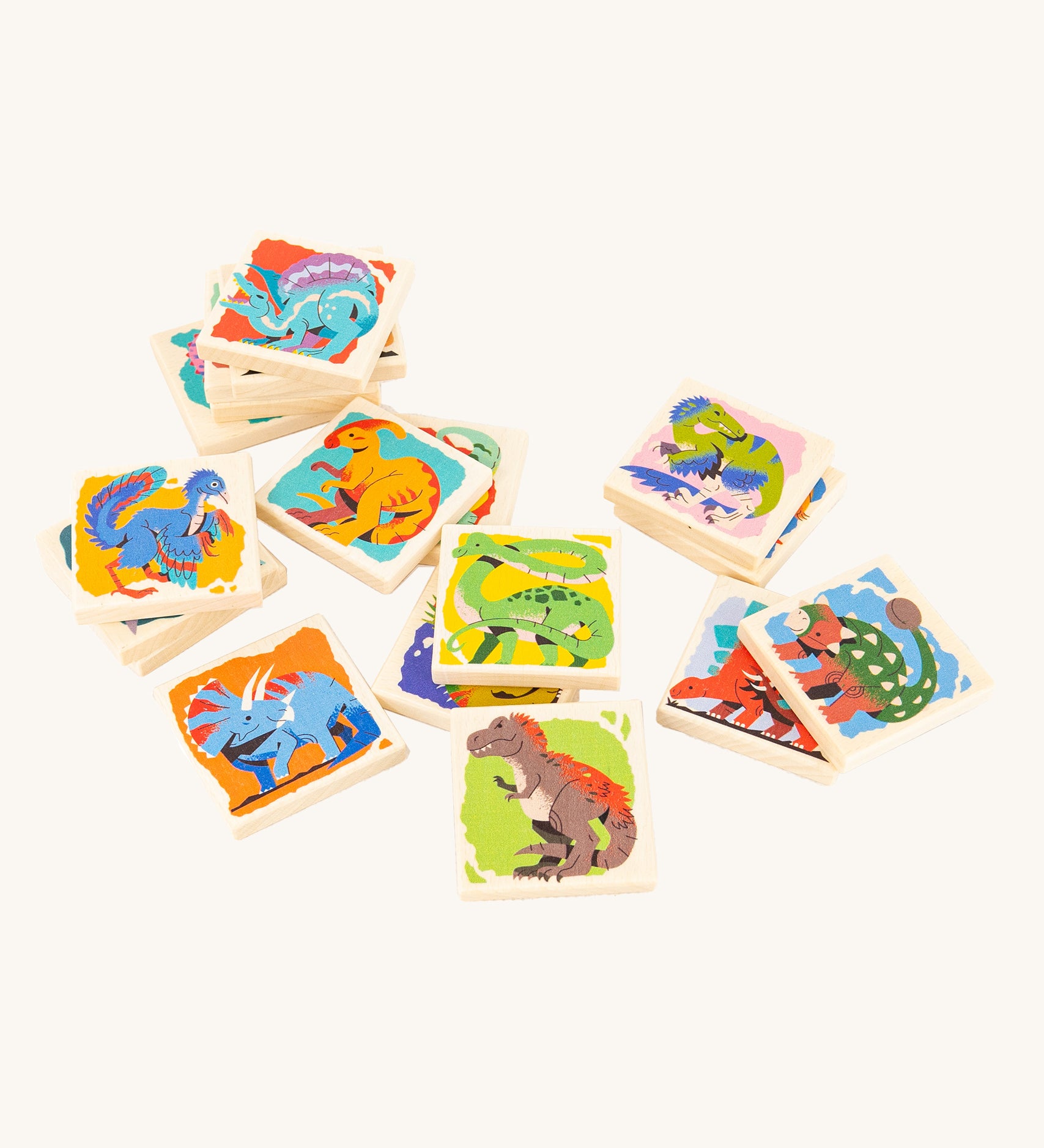 Bajo Dinosaur Memory Game square blocks, stacked on top of each other showing the dinosaur pictures on one side of the blocks, on a cream background