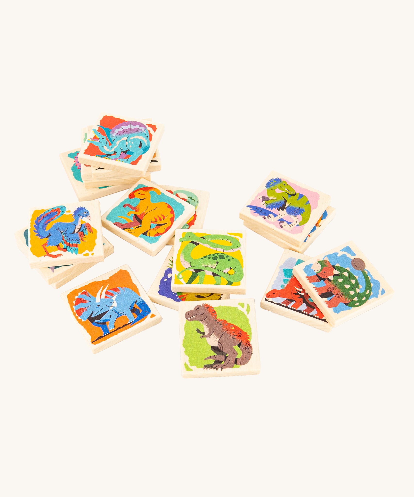 Bajo Dinosaur Memory Game square blocks, stacked on top of each other showing the dinosaur pictures on one side of the blocks, on a cream background