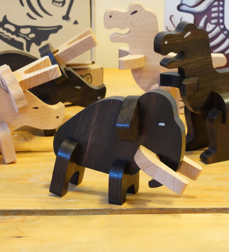 The Bajo Mammoth from the Bajo Puzzle & Sorter - Black Oak Mammoth, with other Bajo Puzzle Sorter figures on a wooden table