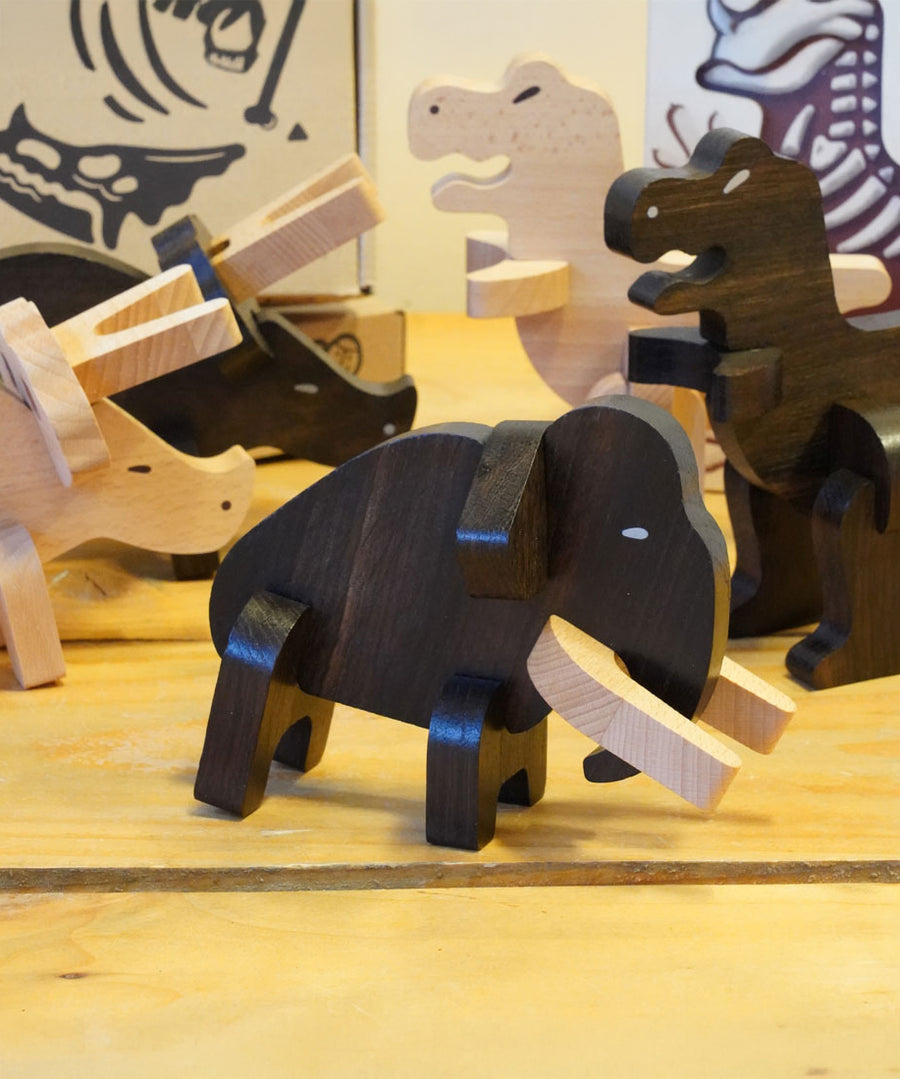 The Bajo Mammoth from the Bajo Puzzle & Sorter - Black Oak Mammoth, with other Bajo Puzzle Sorter figures on a wooden table