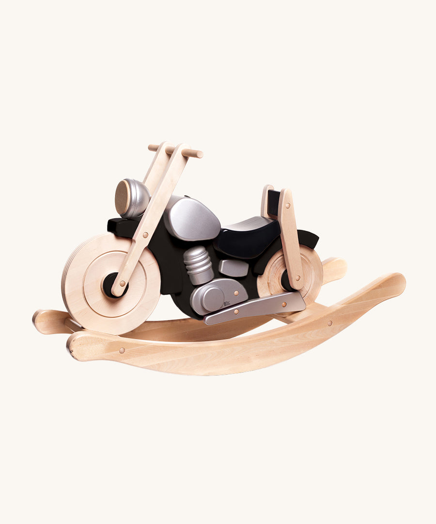 Bajo Rocking Motorbike - Black, is a large ride-on wooden motorcycle with a black body, silver detailing and natural wood rocking arches. Designed to be sat on and ridden, this toy bike is perfect for imaginative and creative play