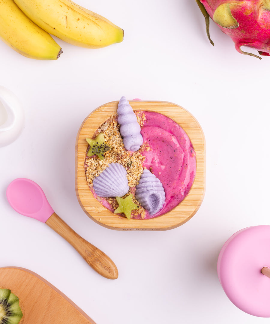 A pink and purple desert with fresh fruit in the Eco Rascals Bamboo Bowl & Spoon Weaning Set in pink silicone.