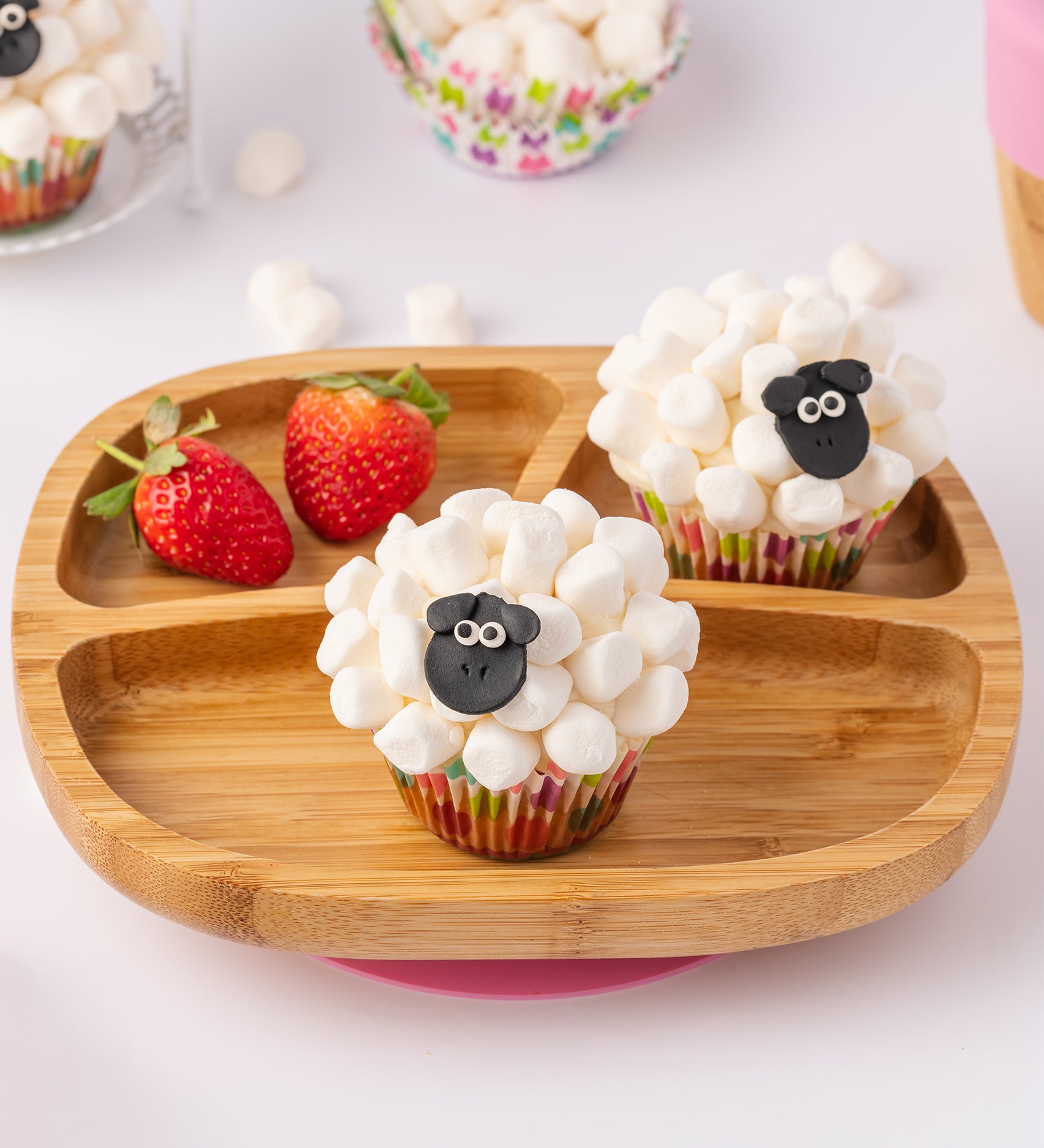 Bamboo baby section plate with strawberries and marshmallow cupcakes. 