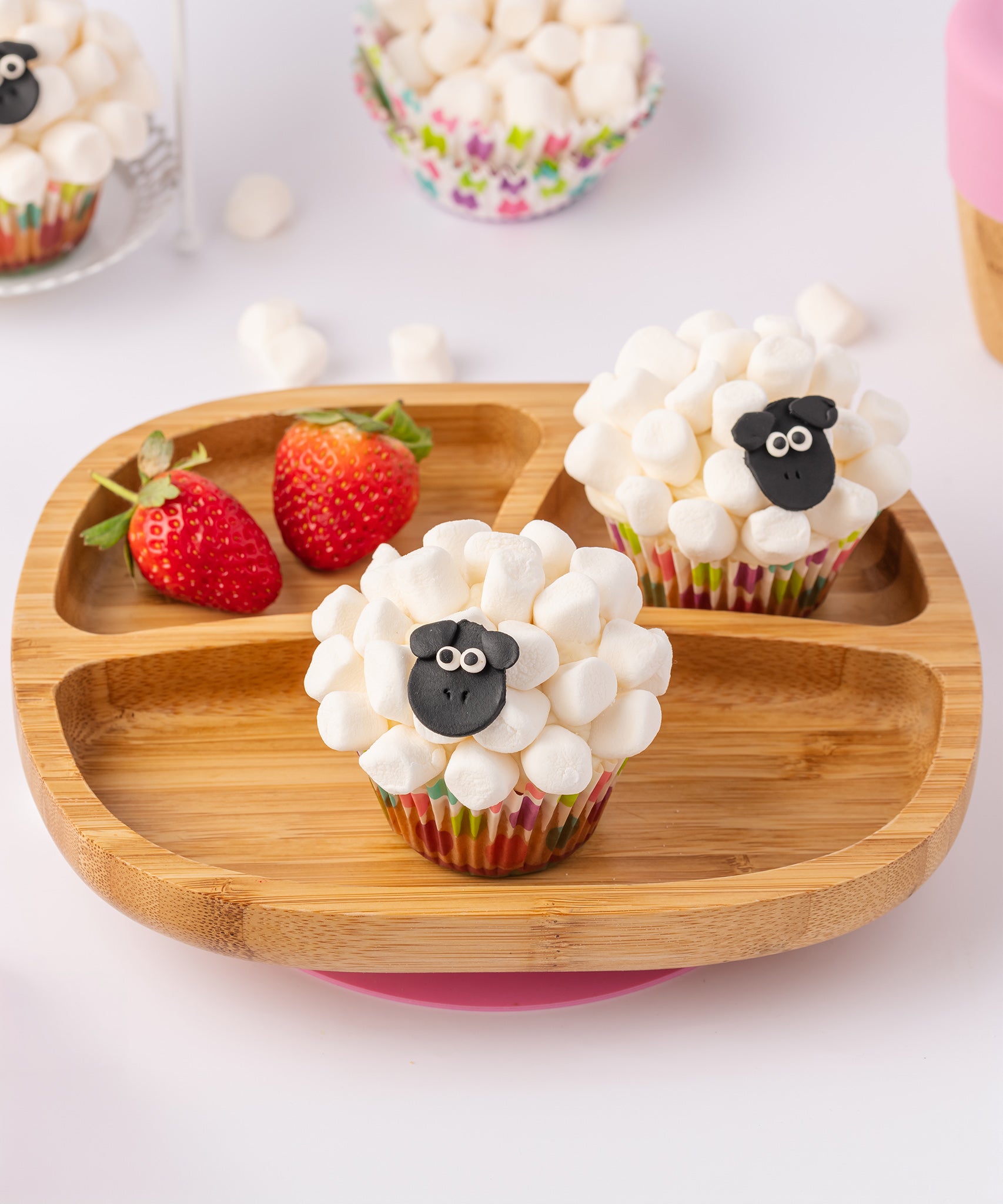 Bamboo baby section plate with strawberries and marshmallow cupcakes. 