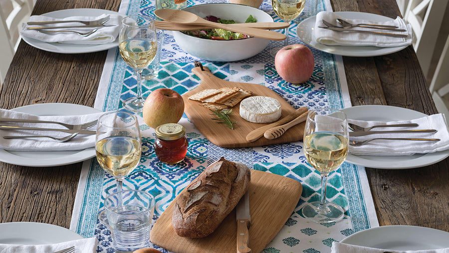 A dinner table set with Bambu chopping boards and Bambu salad spoons