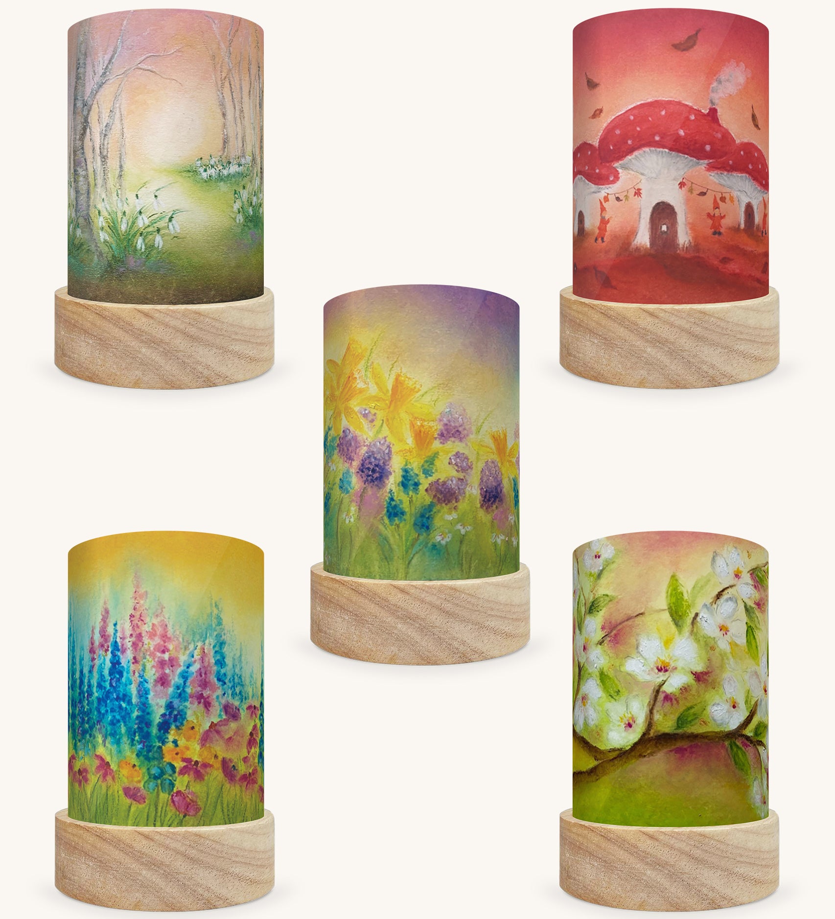 The Season Illustration Set by Baulkje Exler, featuring 5 different Toverlux Magic Lantern Silhouettes which are: Burst Of Spring, White Blossom, Burst Of Summer, Toadstool Village and Snowdrops. The image is on a cream background.