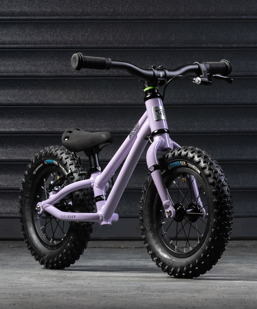 A closer look at the Early Rider Big Foot Balance Bike - Violet Haze, stood in front of a grey background and is on light grey flooring