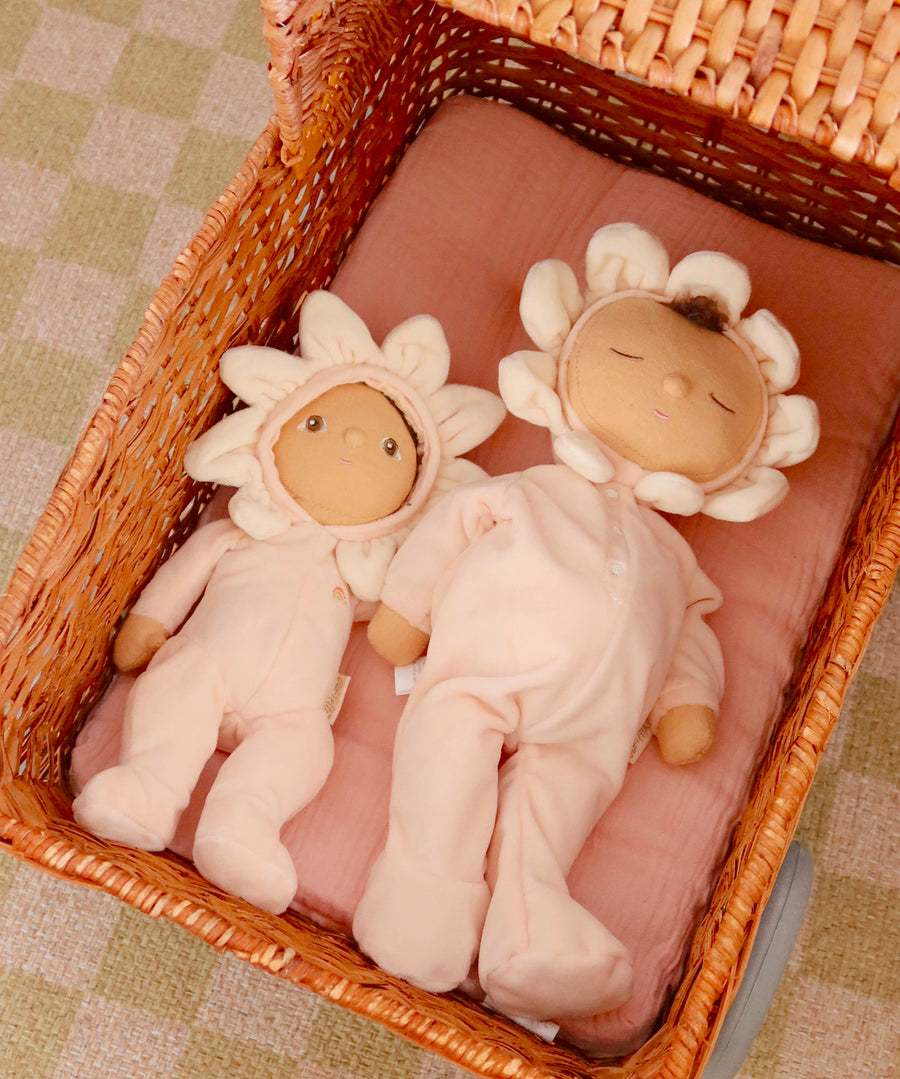 The light cream dinkum dolls lying down in the Olli Ella strolley