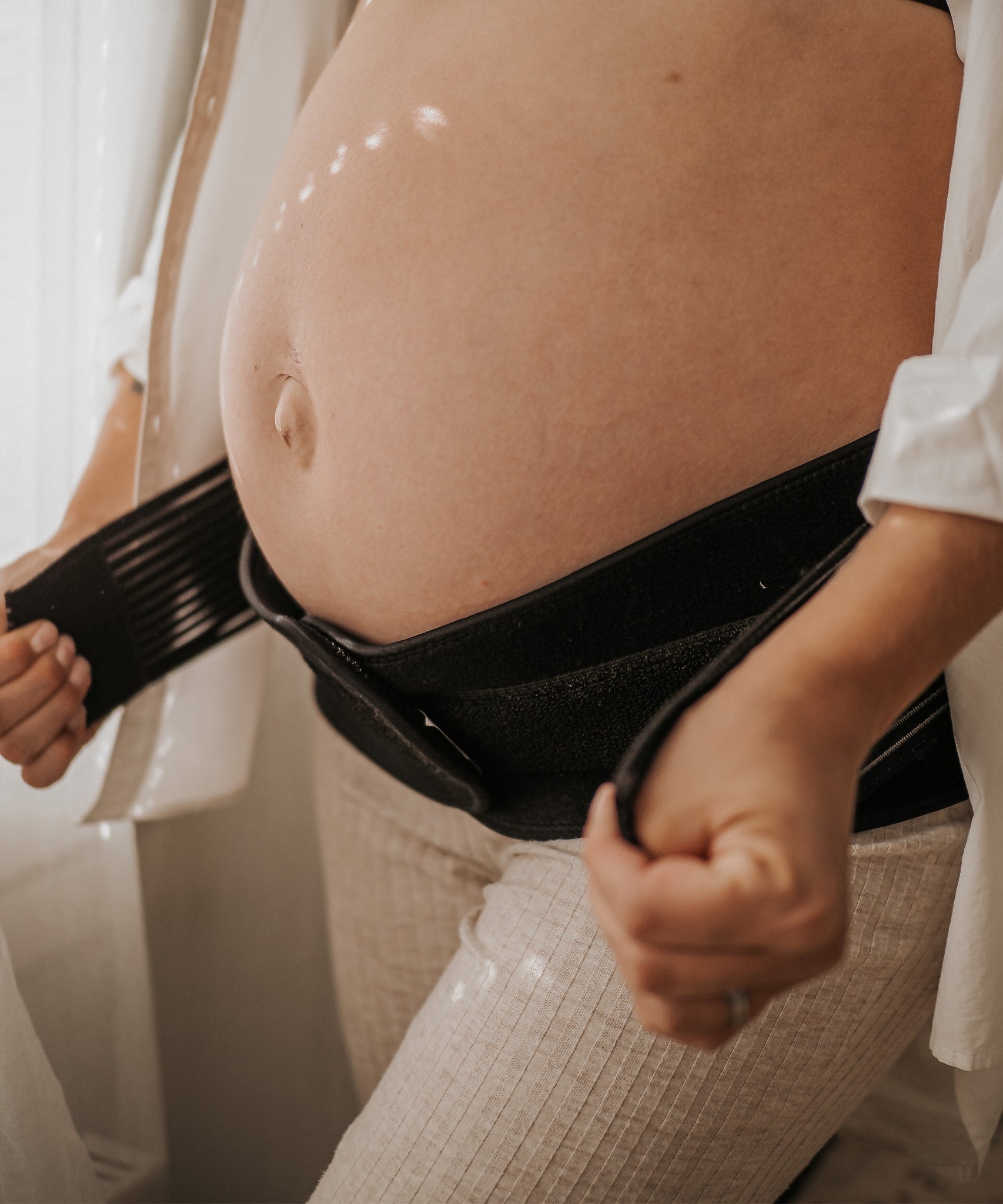 A closer look at the Lola & Lykke Core Relief Pregnancy Support Belt, being worn under a pregnancy bump