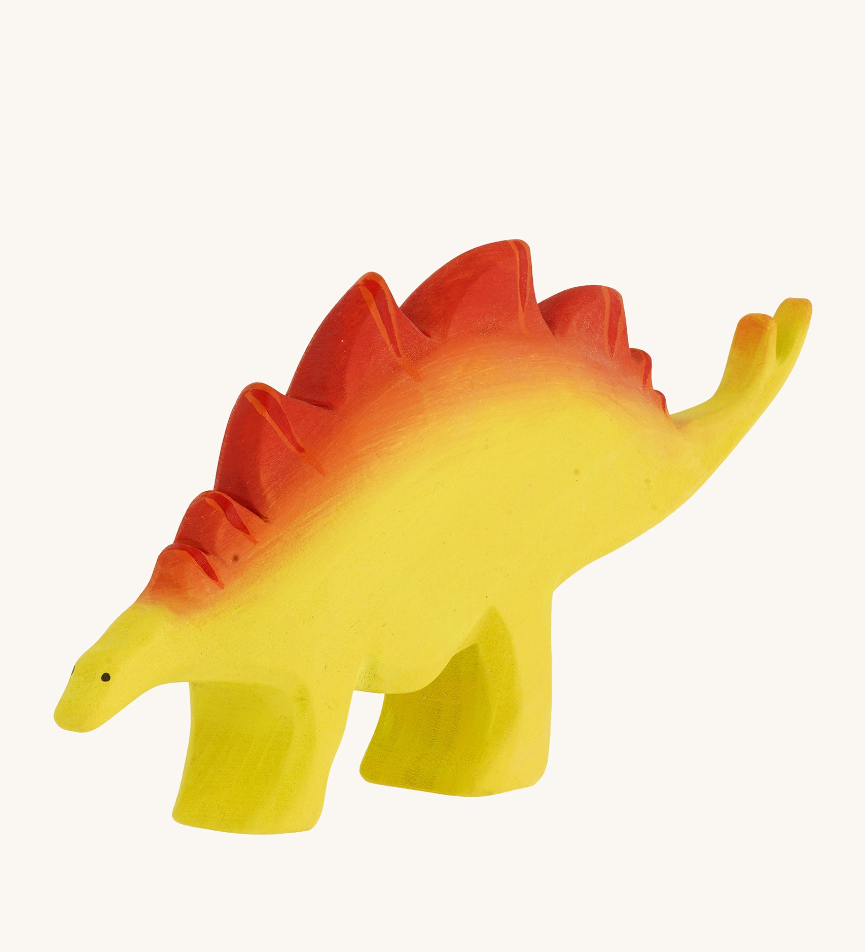 Bumbu big wooden stegosaurus dinosaur toy figure on a plain background.