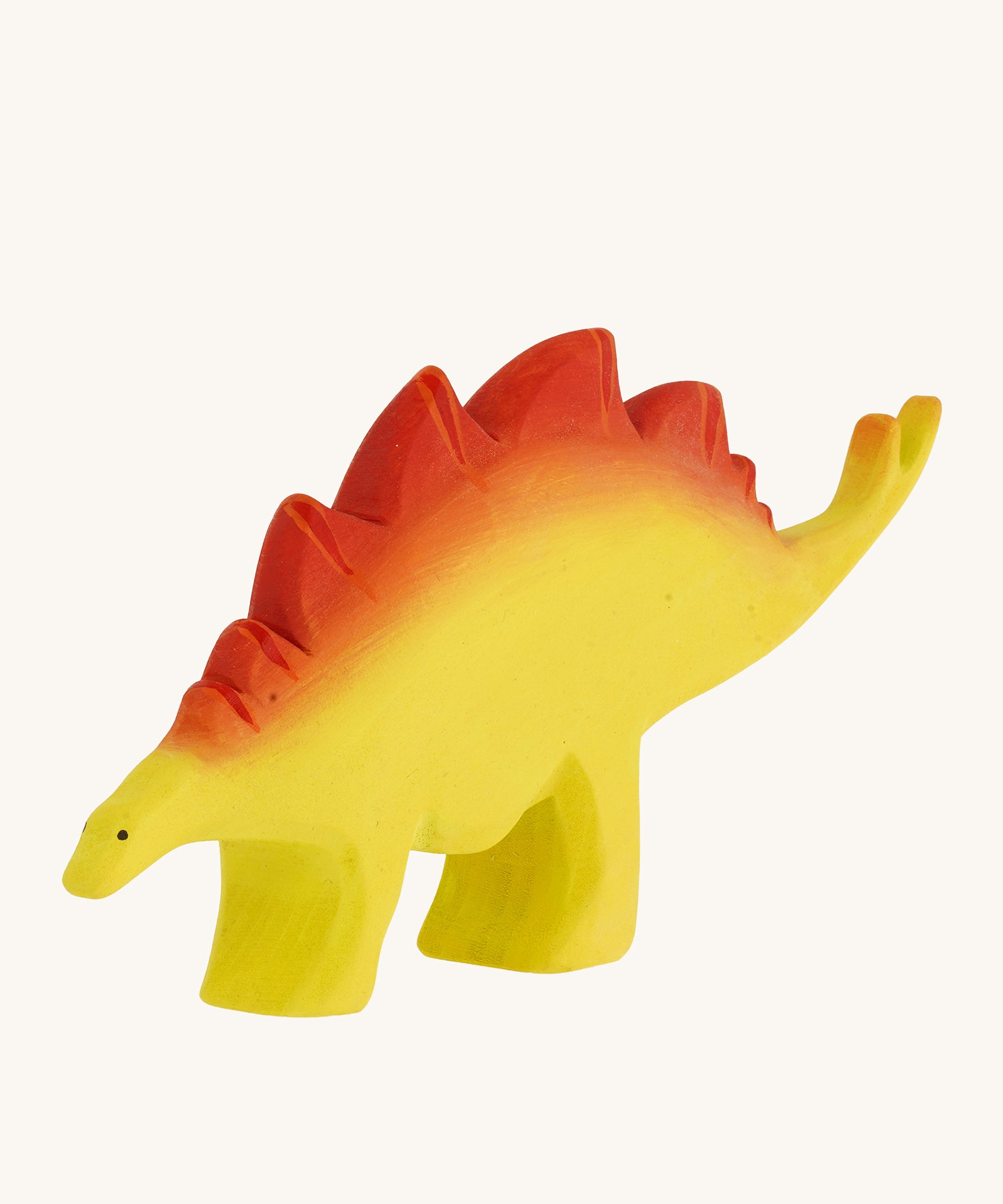 Bumbu big wooden stegosaurus dinosaur toy figure on a plain background.