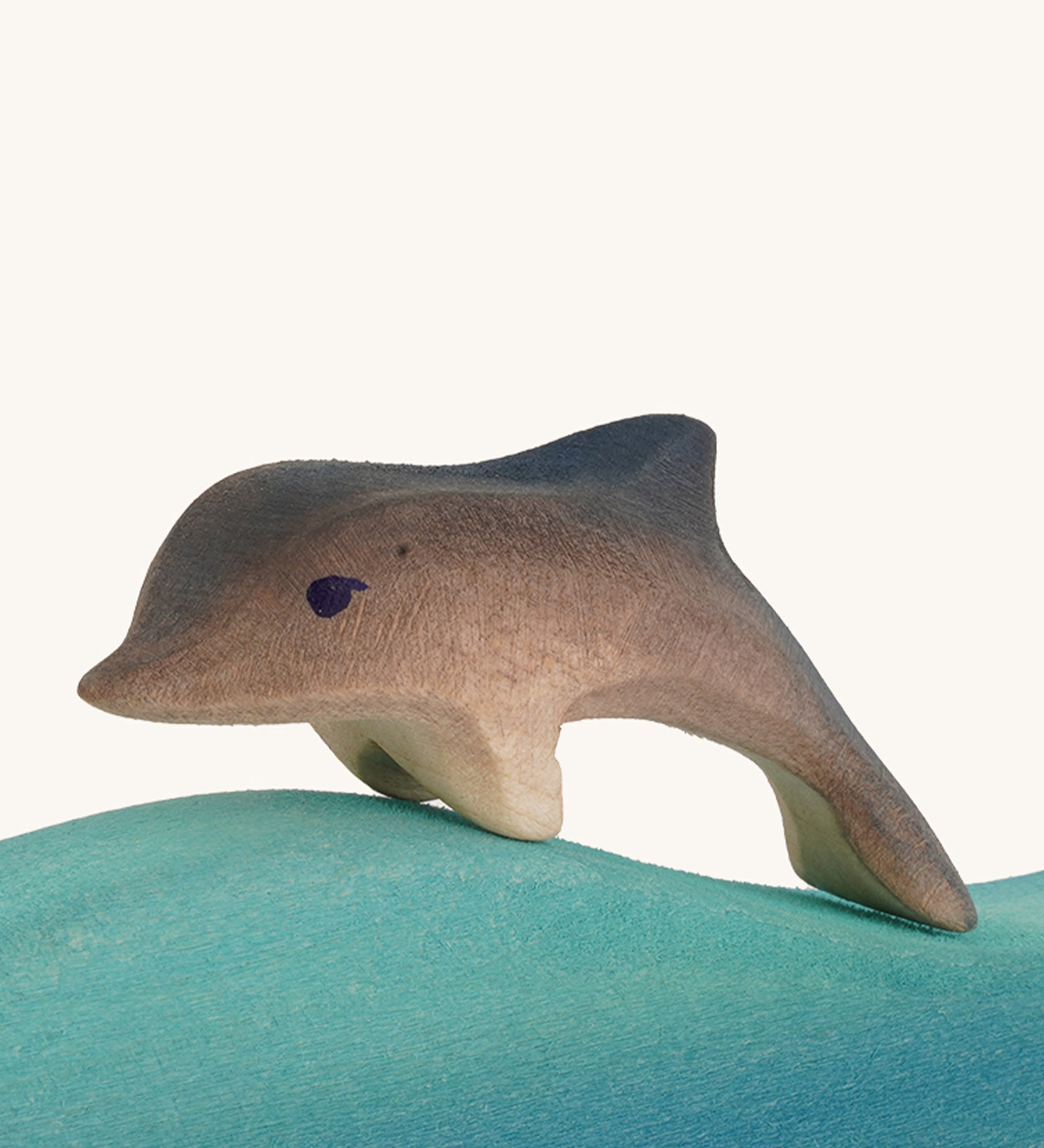 Bumbu wooden baby dolphin figure.