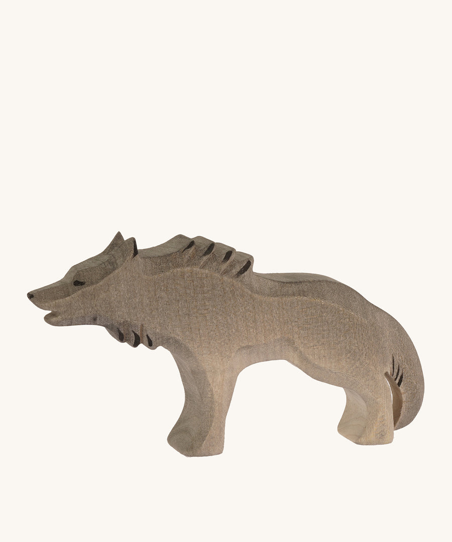 Bumbu wooden angry wolf figure on a plain background.