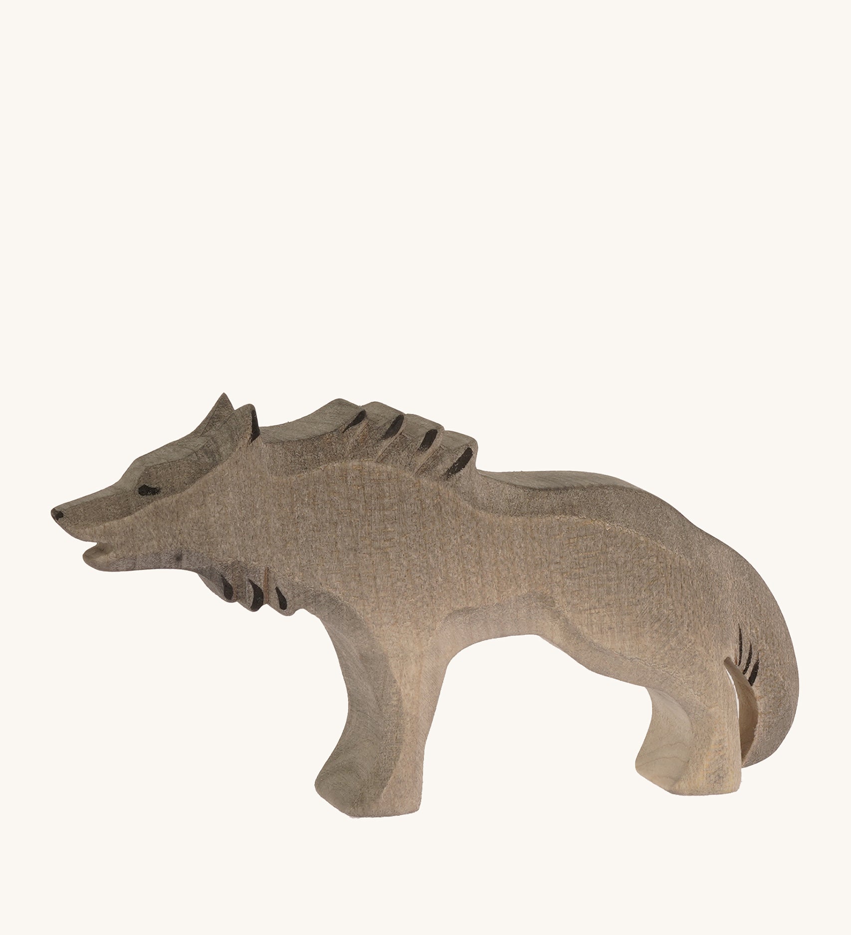 Bumbu wooden angry wolf figure on a plain background.