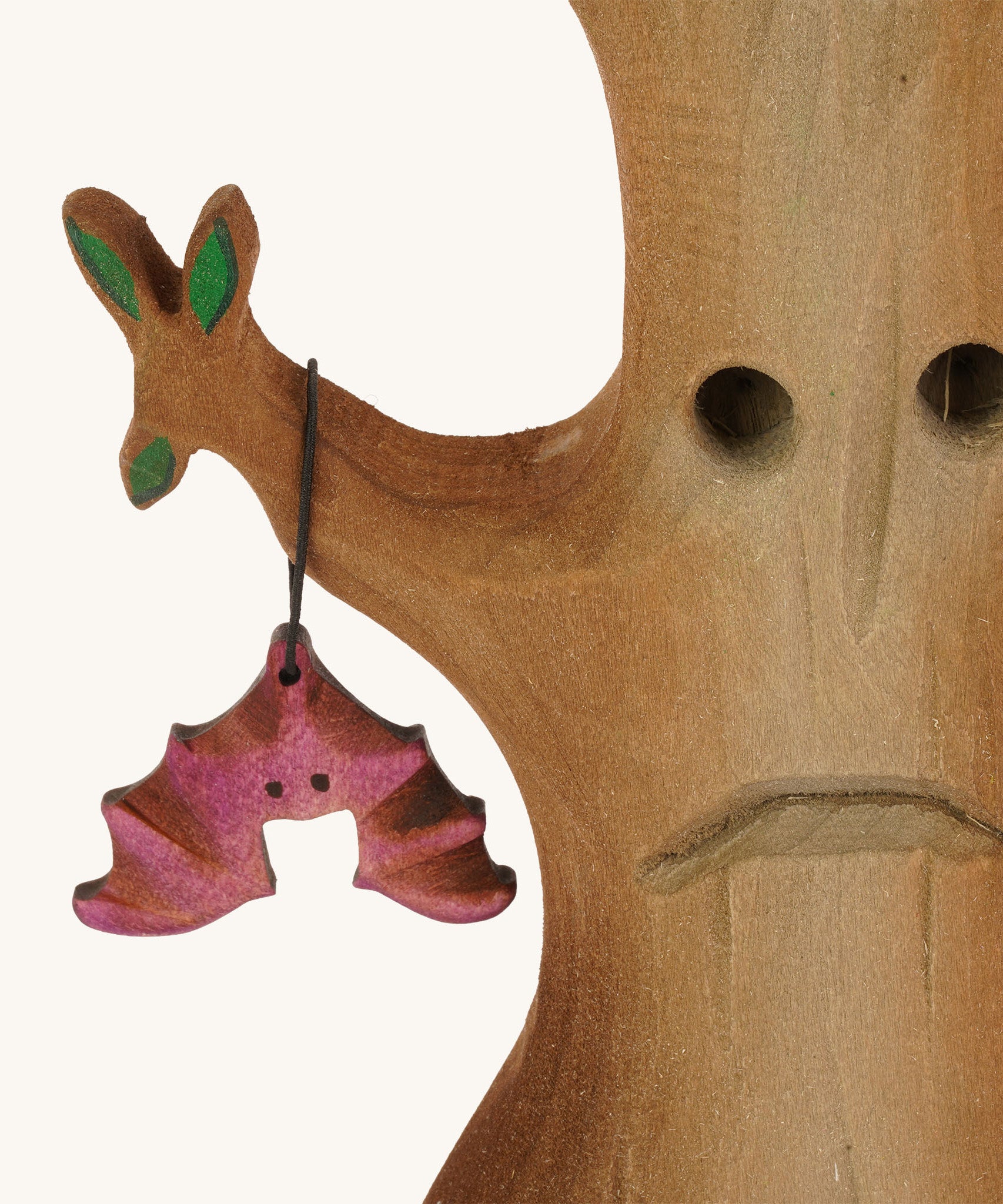 A close up of the Bumbu wooden hat figure on the Bumbu Halloween tree on a plain background