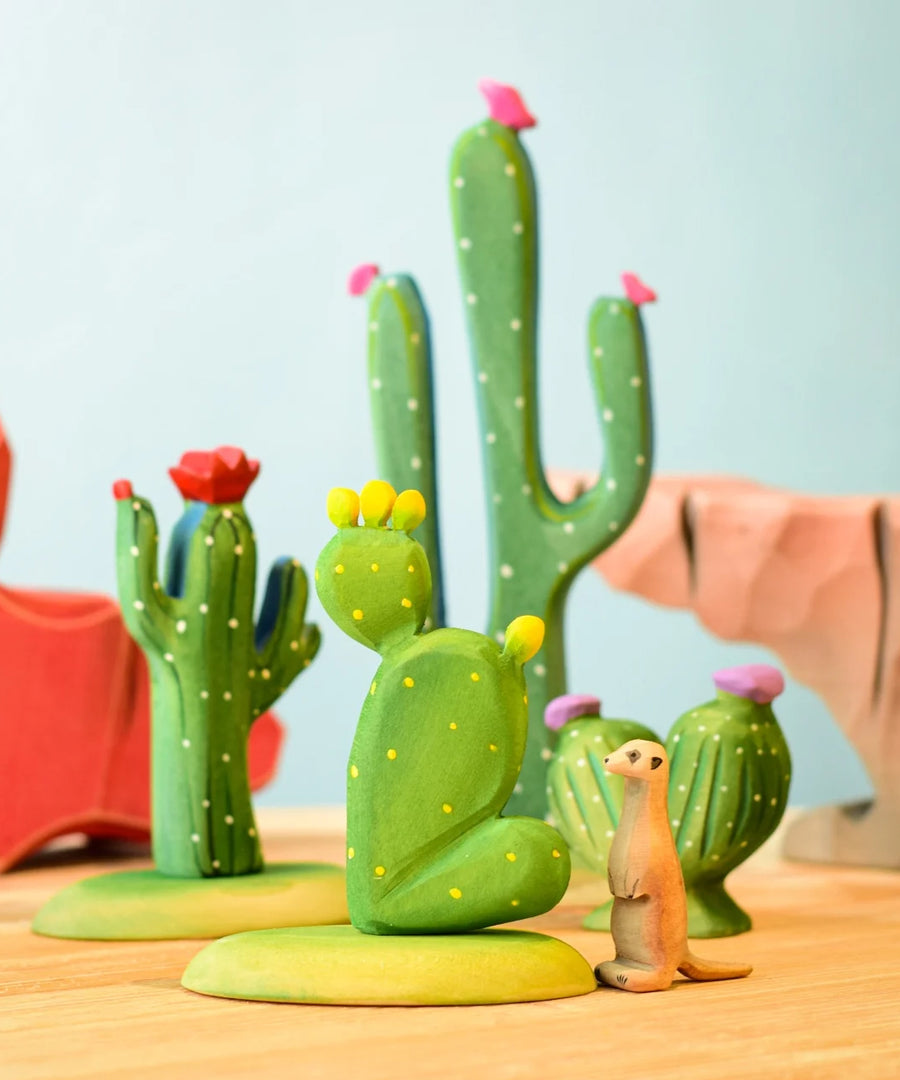 The Bumbu Wooden Saguaro Cactus Figure with red flowers in a desert oasis play scene