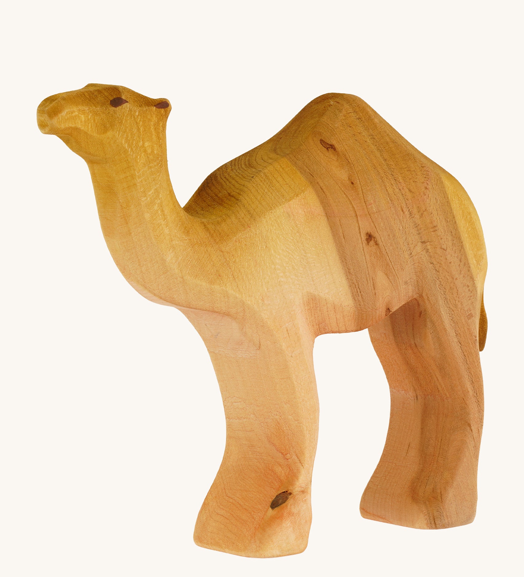 A Bumbu wooden camel figure on a plain background.