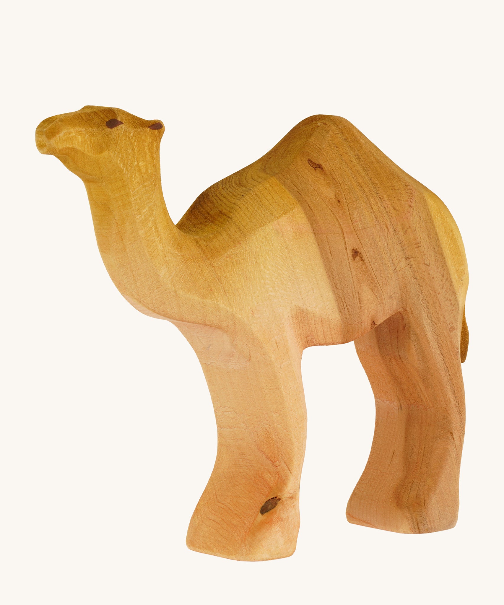 A Bumbu wooden camel figure on a plain background.