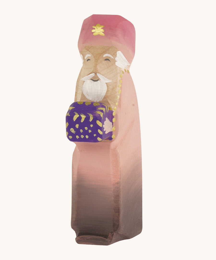 Bumbu wooden caspar three kings figure on a plain background. 