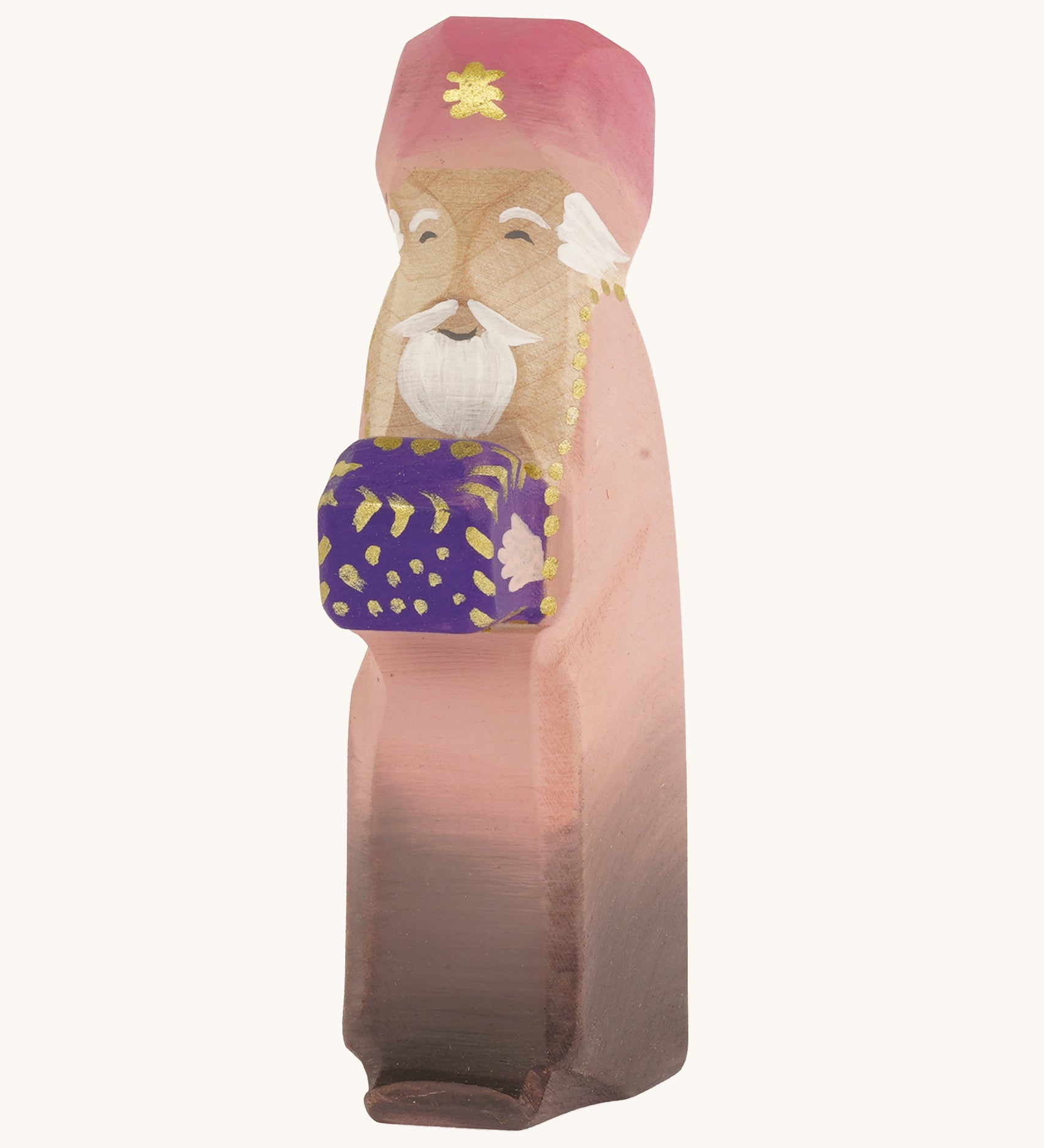 Bumbu wooden caspar three kings figure on a plain background. 