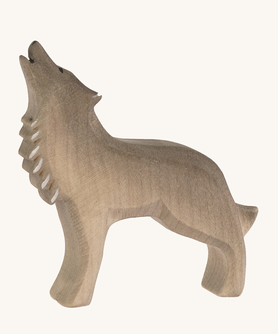 Bumbu wooden howling wolf figure on a plain background.