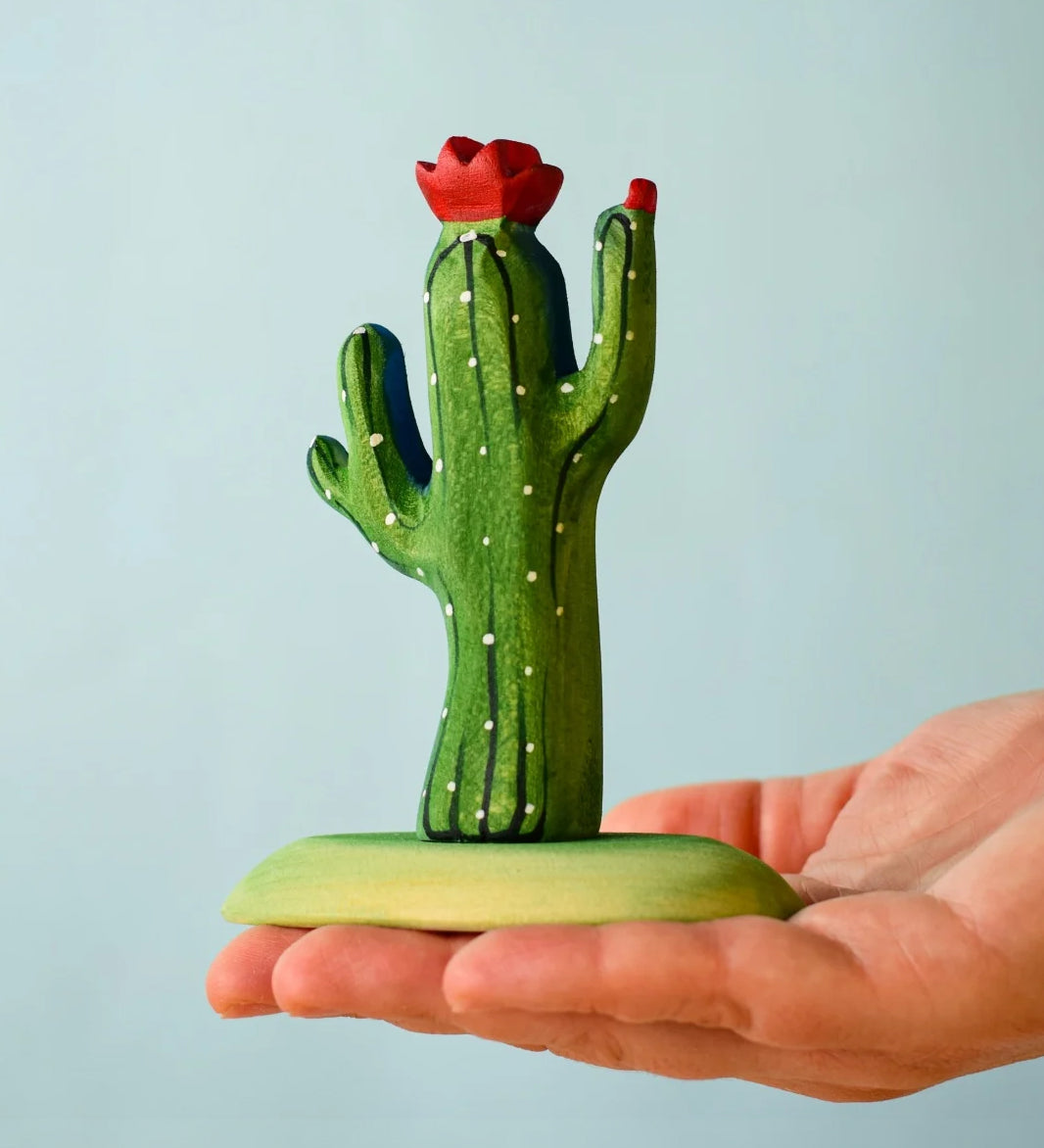 Bumbu Wooden Saguaro Cactus Figure in an adults hand.