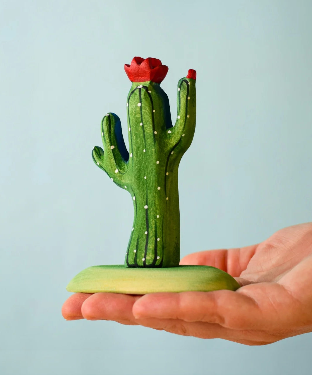 Bumbu Wooden Saguaro Cactus Figure in an adults hand.