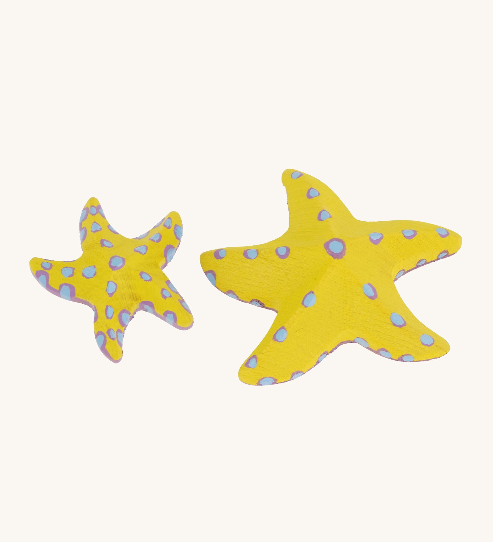 Bumbu yellow wooden starfish set on a plain background. 