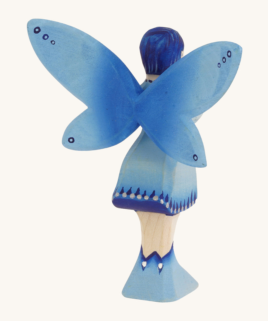 The back of a Bumbu blue Wooden Water Fairy on a plain background.