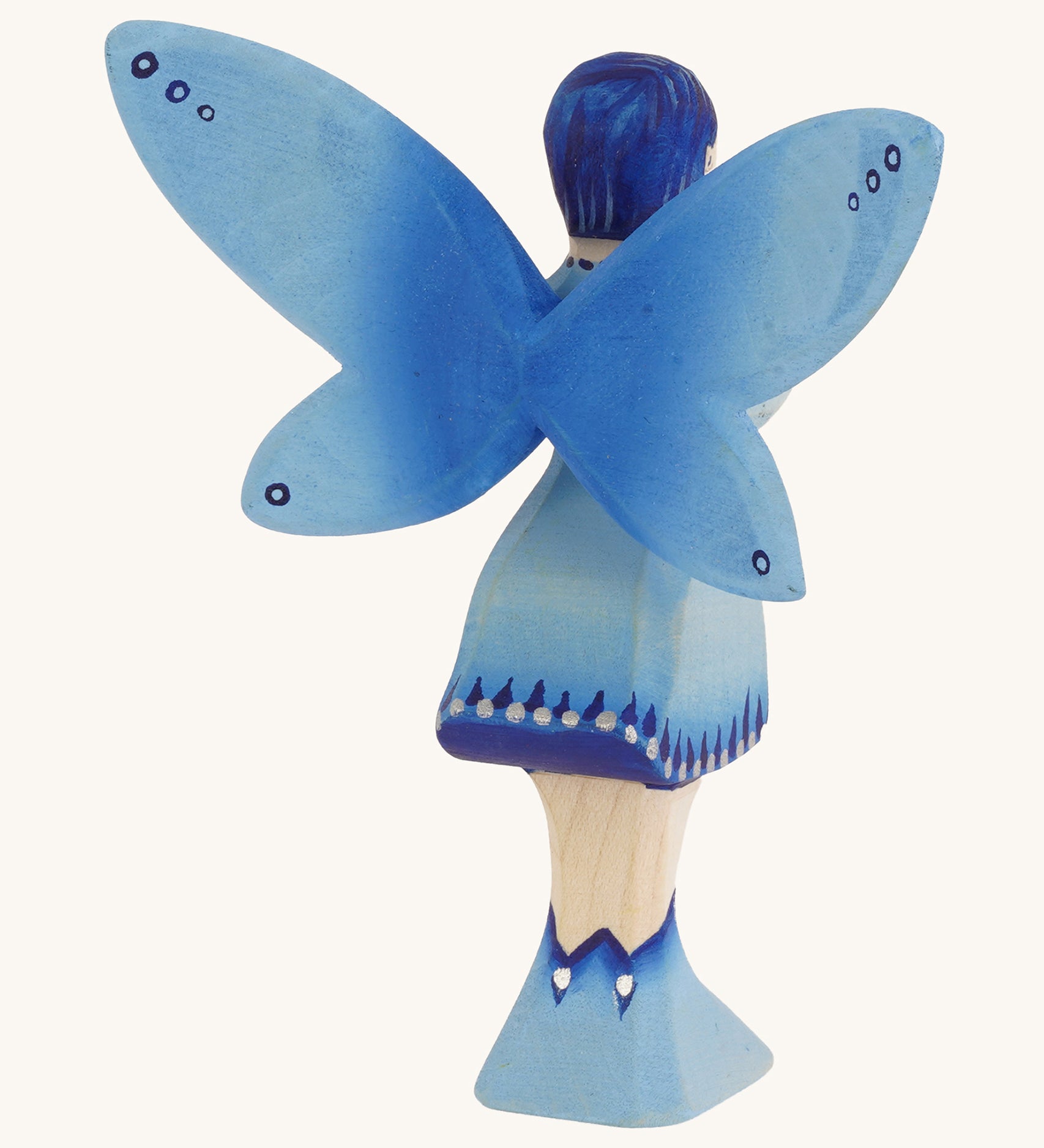 The back of a Bumbu blue Wooden Water Fairy on a plain background.