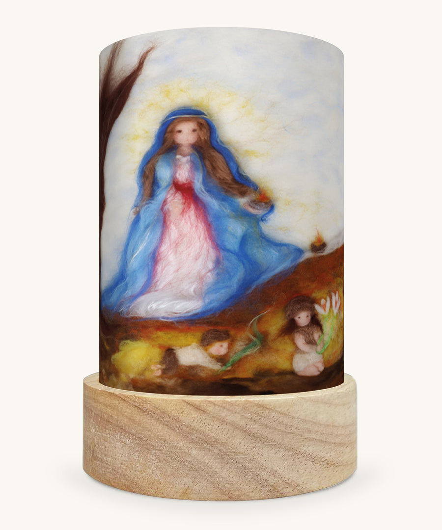 The Candle Mas illustration by Het Wol Feetje sat in a Toverlux Magic Lantern base, on a cream background