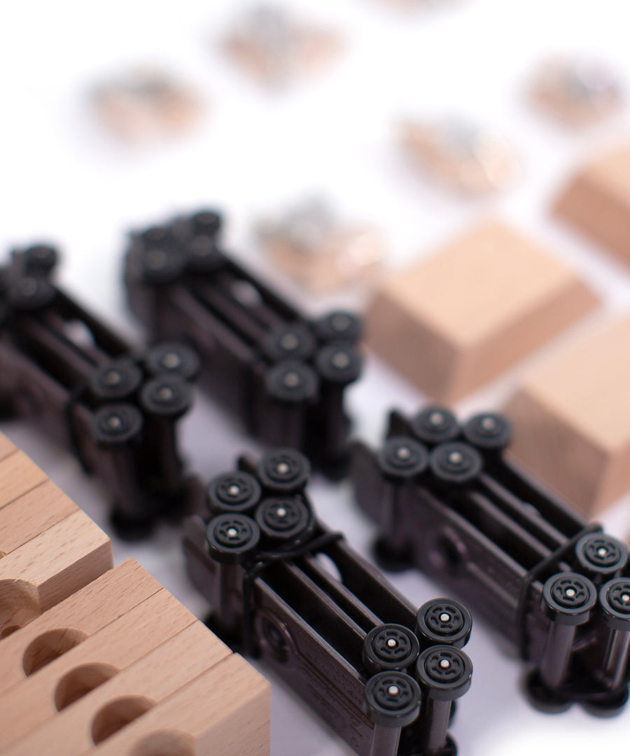 A closer look at the wheel bases of the Candylab DIY Candycar Castor Set - 12 Pack, with wooden blocks and car parts surrounding