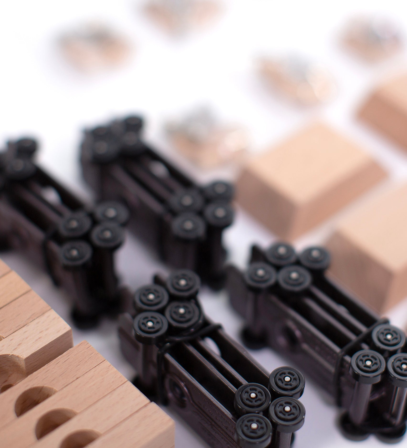 A closer look at the wheel bases of the Candylab DIY Candycar Castor Set - 12 Pack, with wooden blocks and car parts surrounding