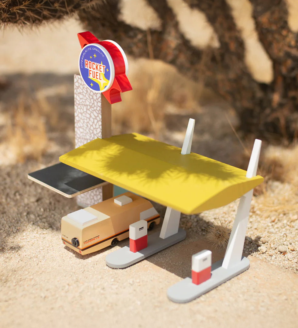 The Candylab Rocket Fuel Station under the shade of a cactus with a desert background