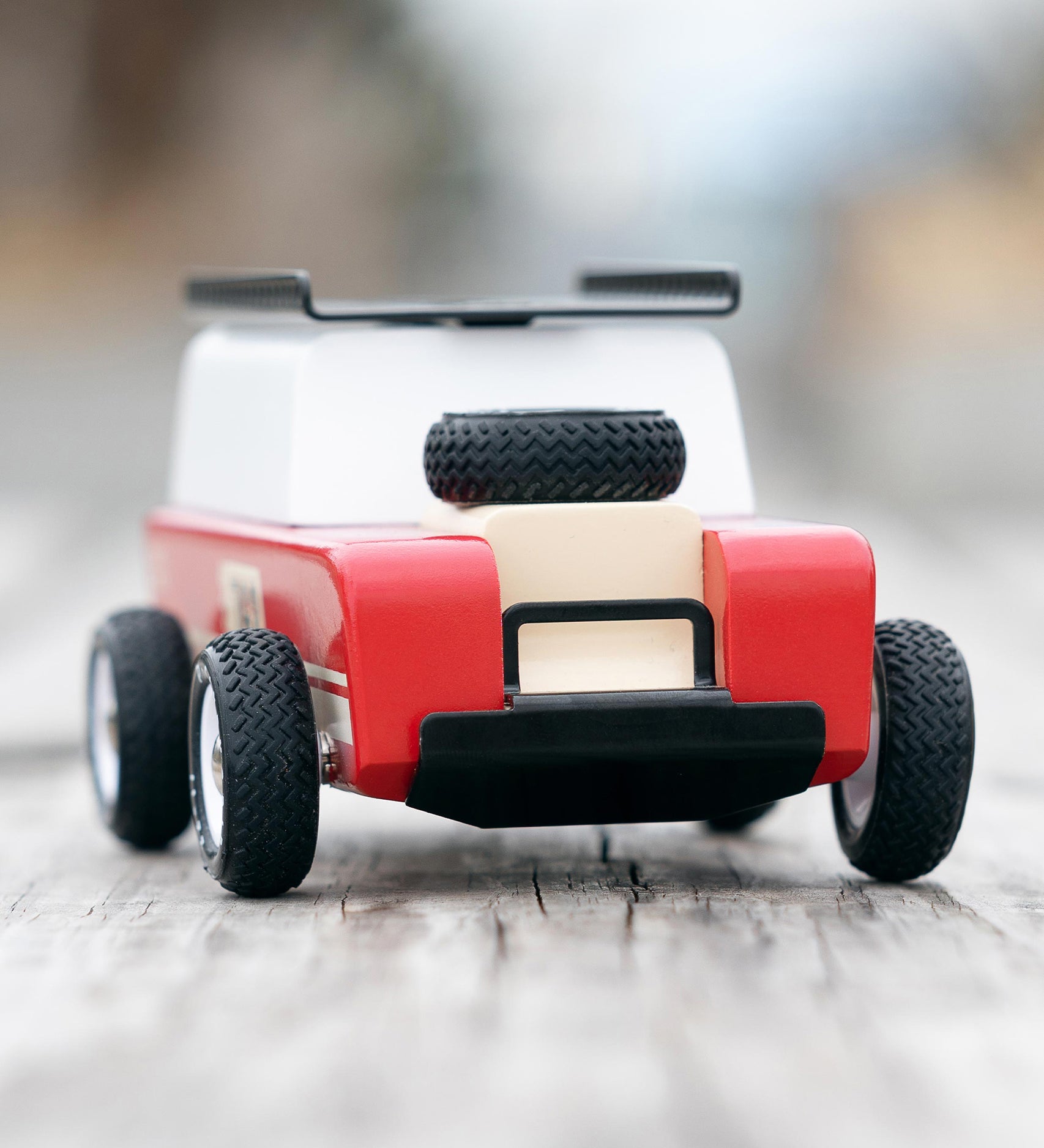 The front of the Candylab Drifter Nigel, showing the spare tire on the car bonnet, and the black detailing on the front of the car. The car is stood on a light wooden base