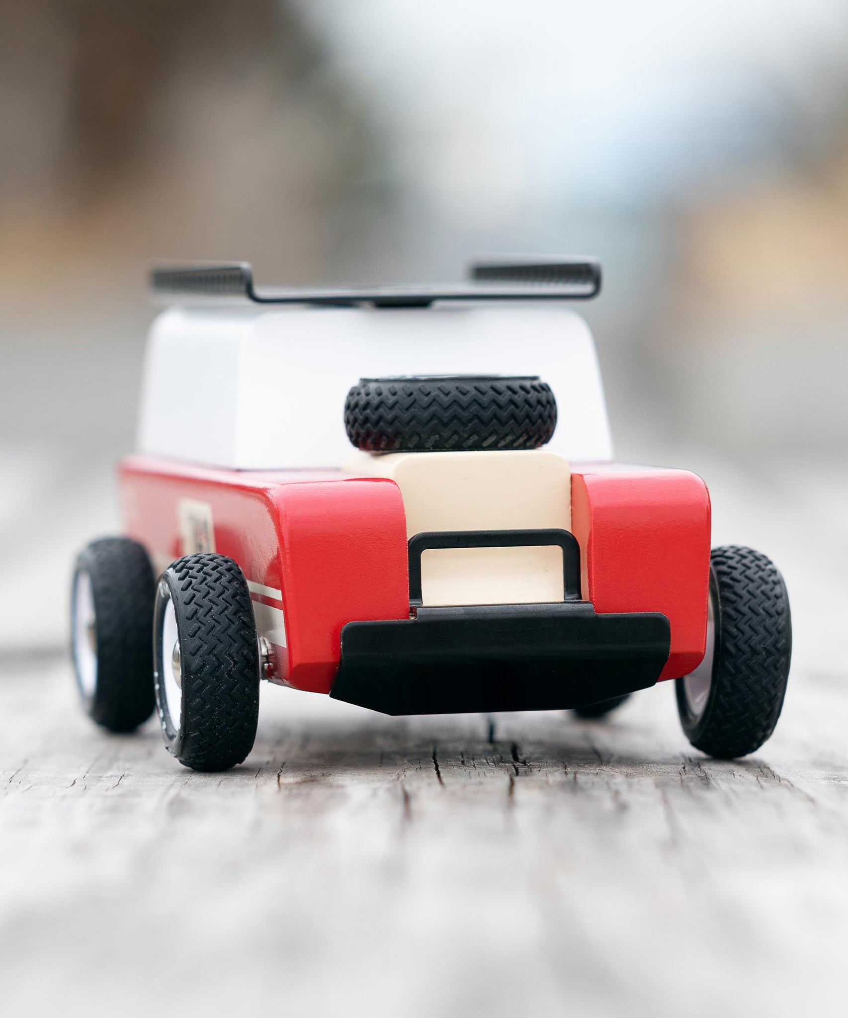 The front of the Candylab Drifter Nigel, showing the spare tire on the car bonnet, and the black detailing on the front of the car. The car is stood on a light wooden base