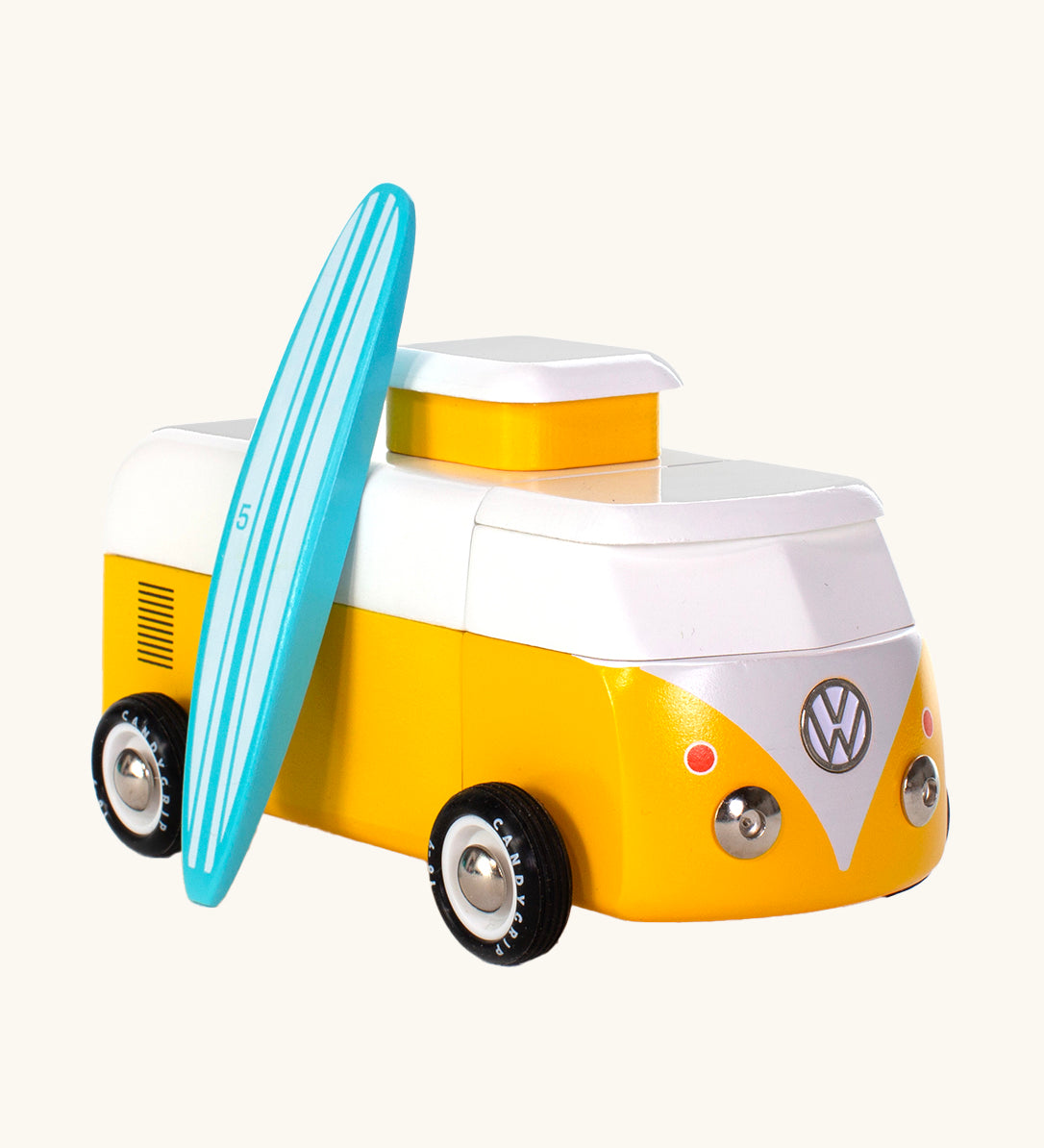 The Candylab VW Beach bus in yellow, with a wooden blue and white stripe surf board propped up next to the van, The image is on a cream background