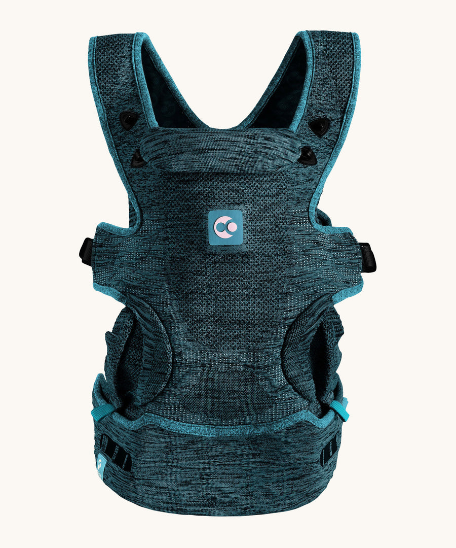 The Carifit+ Fabric Baby Carrier in Coll Green, sown from the front on a cream background