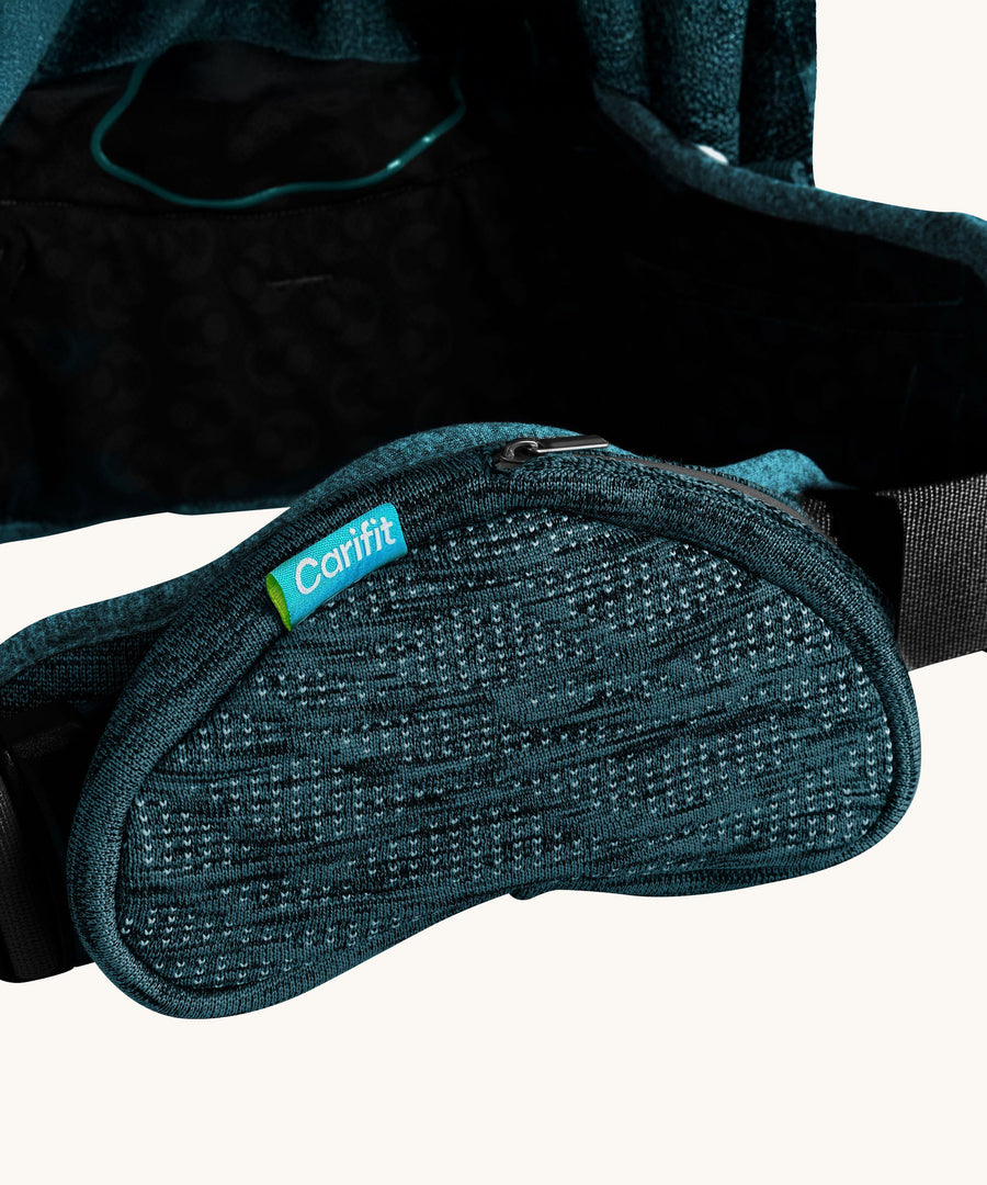 A closer look at the zip up storage pouch on the waist band of the Carifit+ Baby Carrier in Cool Green. This is also available on the Cool Grey carrier