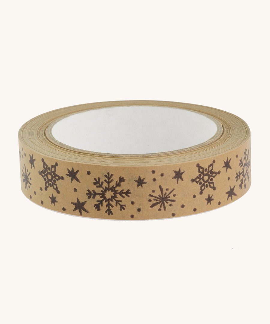 Christmas paper tape with brown snowflake design on cream background.