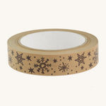 Christmas paper tape with brown snowflake design on cream background.