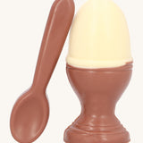 Cocoa Loco Fairtrade organic chocolate Easter egg set. A solid white chocolate egg, shaped like a boiled egg, in a milk chocolate eggcup with a spoon. Handmade in the UK.