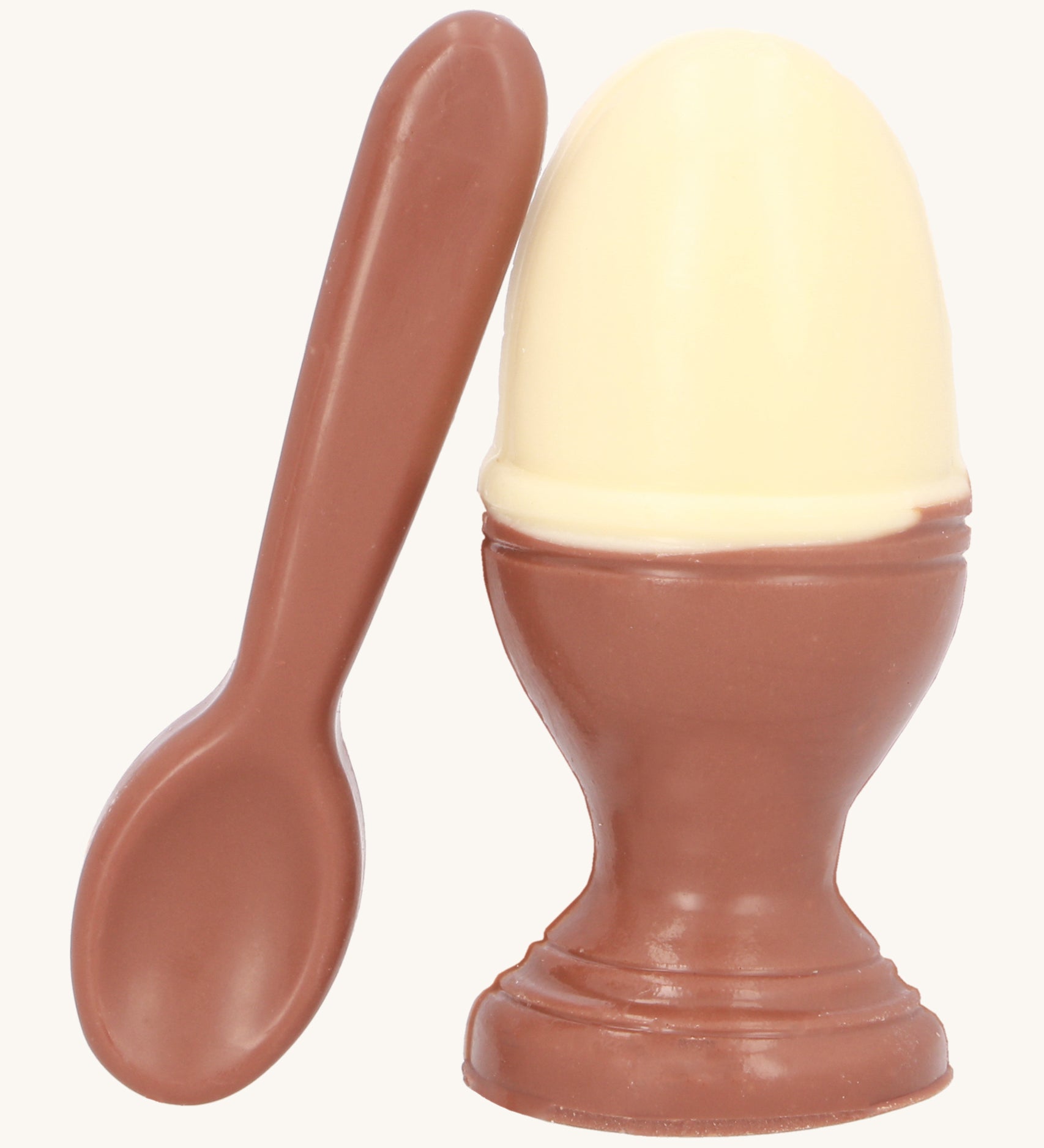 Cocoa Loco Fairtrade organic chocolate Easter egg set. A solid white chocolate egg, shaped like a boiled egg, in a milk chocolate eggcup with a spoon. Handmade in the UK.