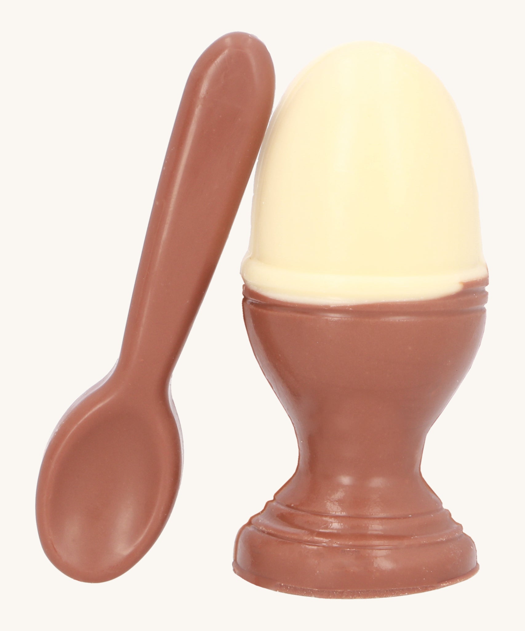 Cocoa Loco Fairtrade organic chocolate Easter egg set. A solid white chocolate egg, shaped like a boiled egg, in a milk chocolate eggcup with a spoon. Handmade in the UK.