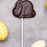 Cocoa Loco organic Fairtrade vegan dark chocolate shaped rabbit lolly. Surrounded by colourful mini easter eggs.