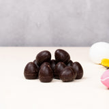 Cocoa Loco organic Fairtrade vegan mini dark chocolate eggs. Small easter eggs are in frame to add a decorative springtime feel.