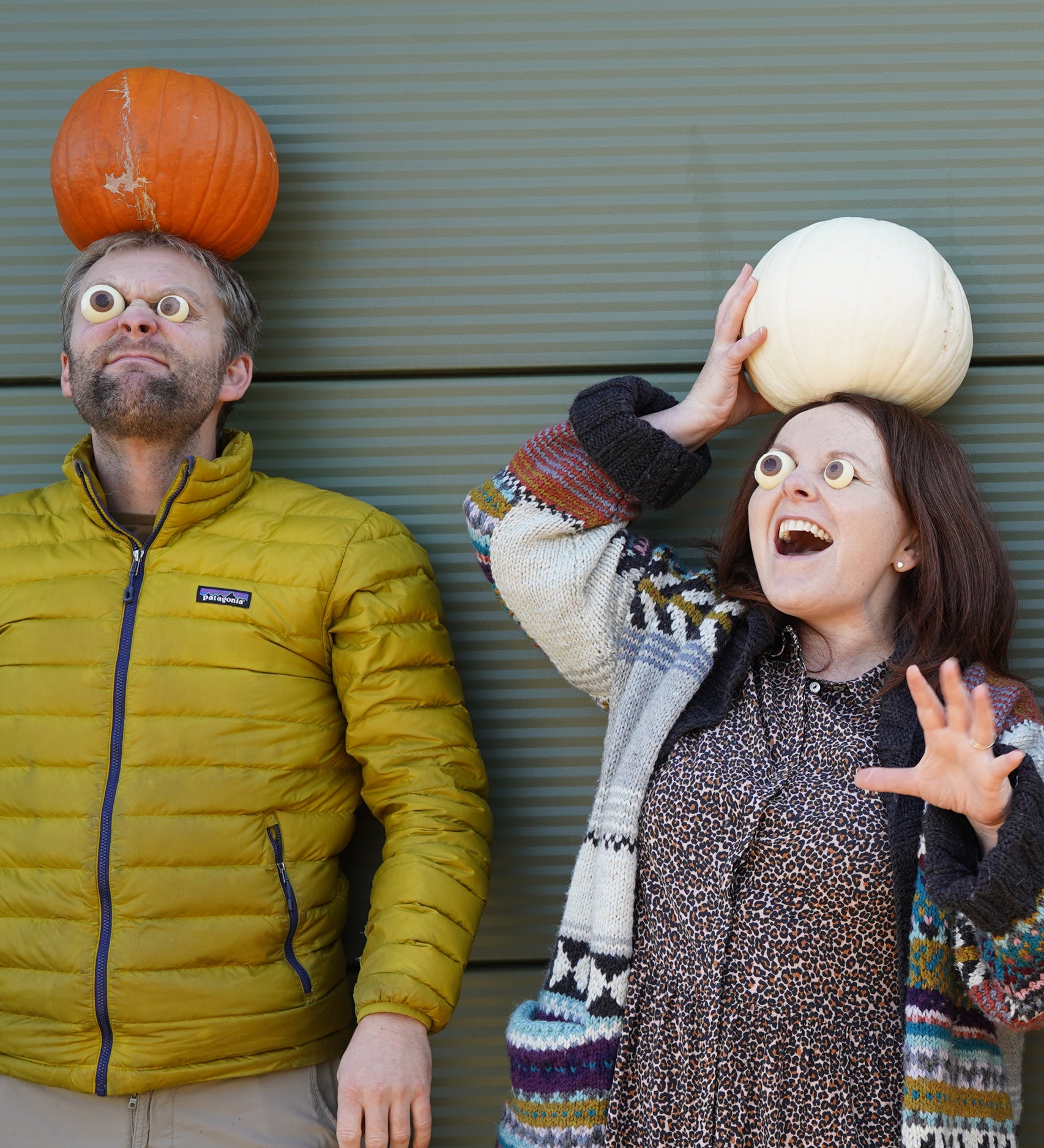 Cocoa Loco Halloween eyeball chocolate worn by Jolene and Pete from team Babipur. They're outside pulling spooky faces with pumpkins on their heads.